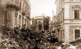 A devastated street in Messina with the remains of the Chiesa delle Anime del Purgatorio in the distance