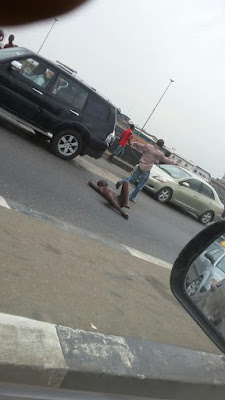 c Photos: Unidentified man strips naked, lies on the road causing traffic in Lagos