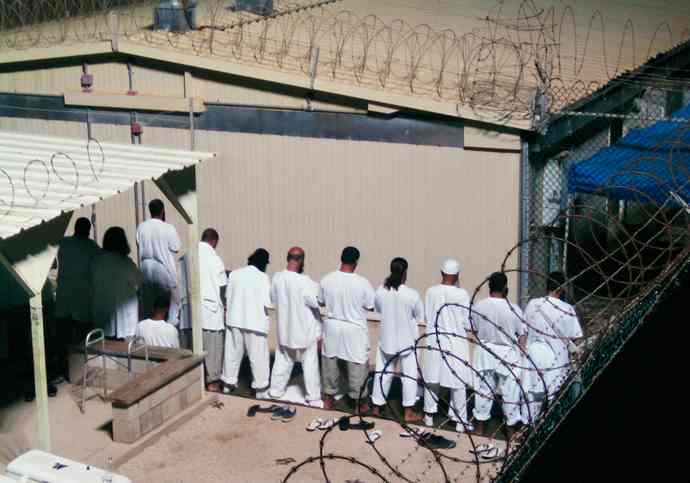 Prisoners praying at Guantanamo Bay prison