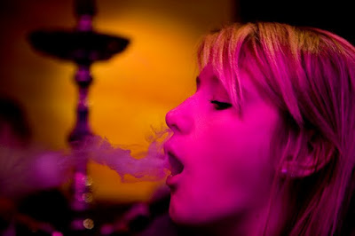 Smoking in pubs? Young girl smoking in a pub