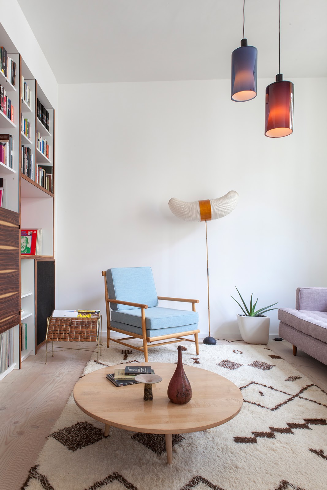 amazing designer loft in berlin with mdi century modern design, noguchi lamp, pattern carpet, pottery collection, light blue armchair