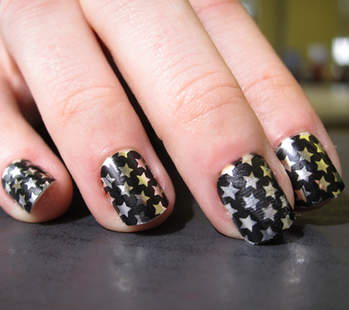Black Nail Art with Silver and Golden Stars