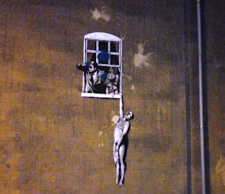 The Banksy artwork Well Hung Lover on Park Street in Bristol