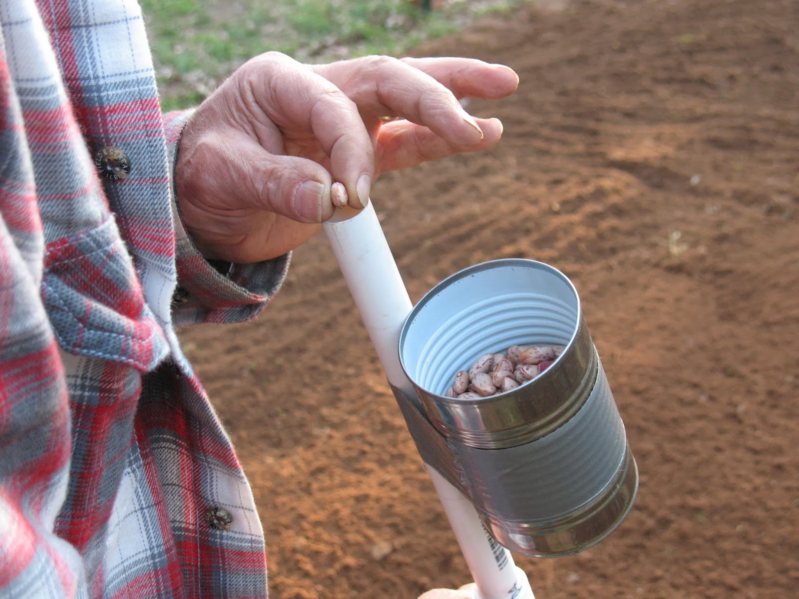 Hand held corn planter