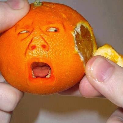 Orange getting peeled and the orange is making a scared face