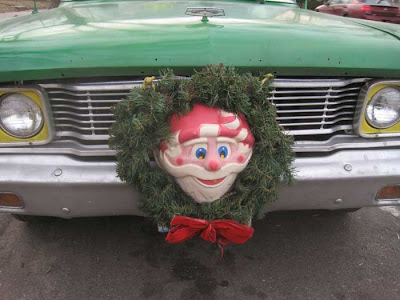 Close up of the grille, with yellow around the headlights and a retro Santa wreath at center
