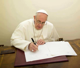 Pope Francis writing