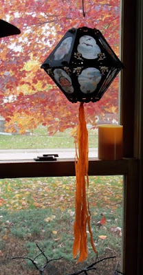 12-sided lantern with pumpkins and blue panes contrasts beautifully with the yellows, oranges, and reds of the autumn landscape from the window view.