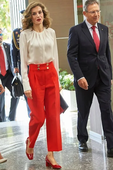 Queen Letizia at Red Cross charity Day. Queen wore Hugo Boss blouse, Hugo Boss red trousers, Adolfo Dominguez clutch, Mango shoes