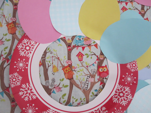 The card eggs being layered and glued on the paper plate
