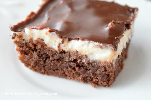brownies with white frosting and chocolate glaze