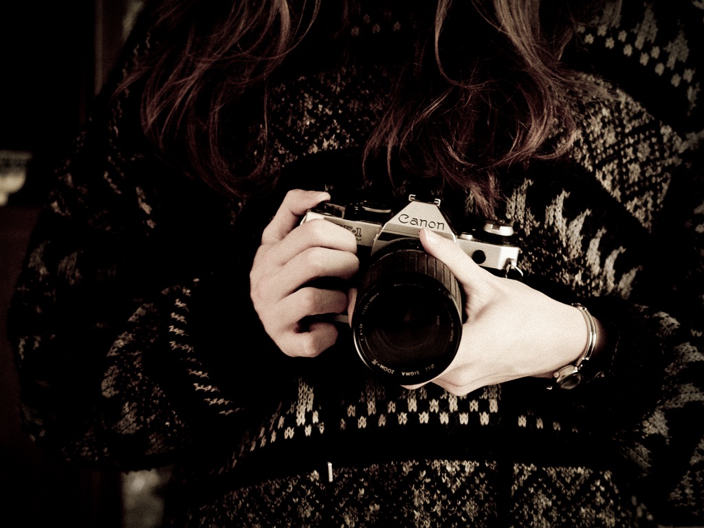 Woman In Black Sweater Holding Canon Dslr Camera Background Wallpaper Reazix