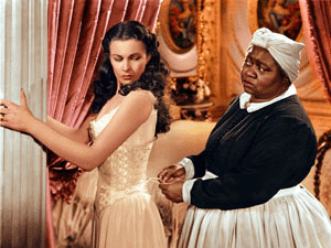 Hattie McDaniel lacing up Scarlet Ohara's corset in Gone with the Wind movieloversreviews.filminspector.com