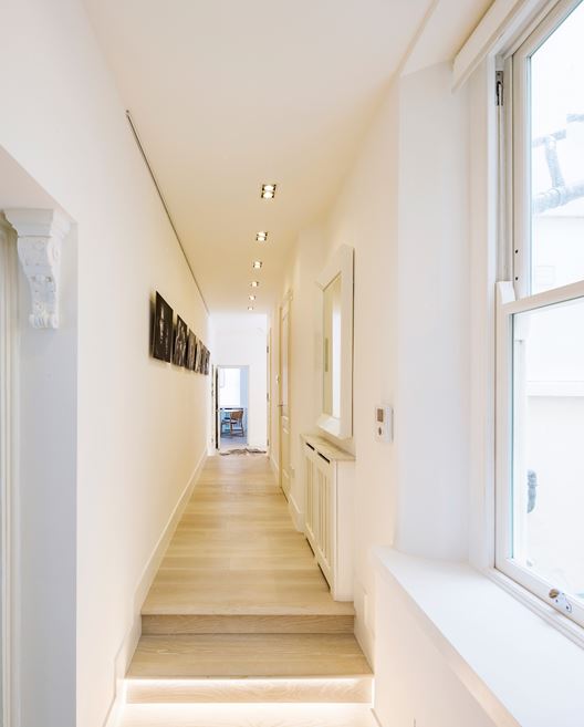 Corridor with light wood floors