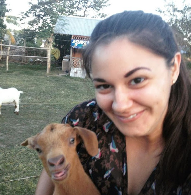 Girl holding goat on farm in Philippines