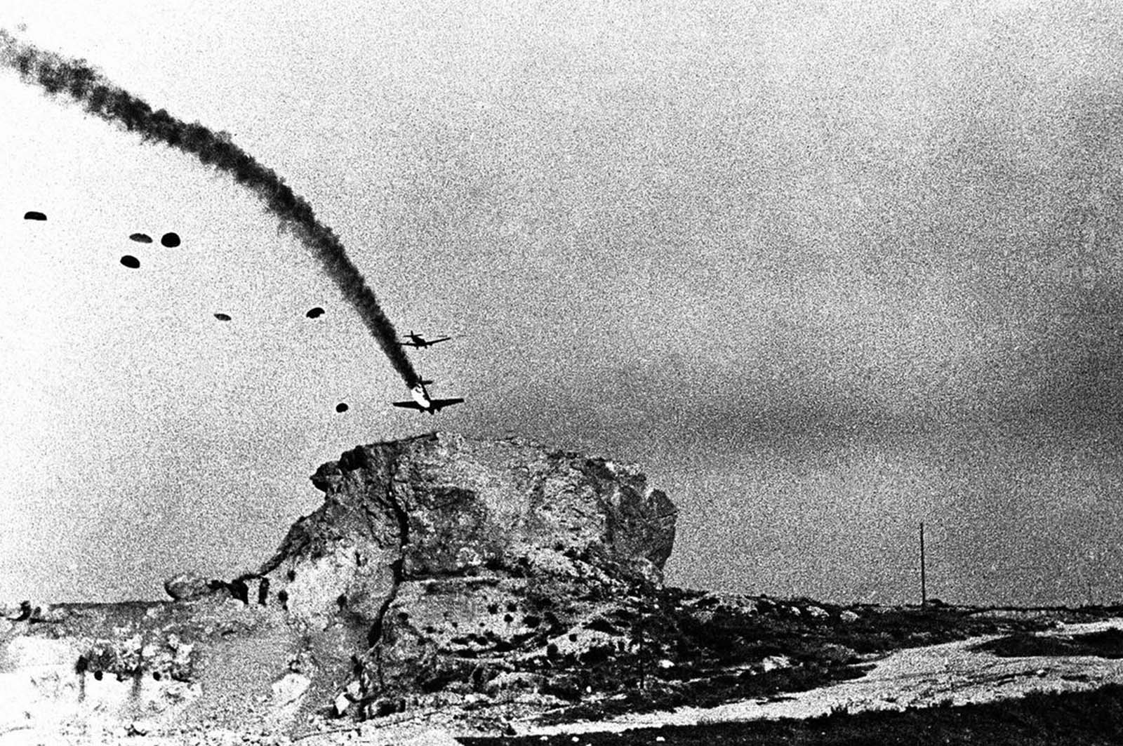 The price paid by German air invaders on the Greek island of Crete. While fighter aircraft patrolled the area, troop-carrying aircraft followed, escorted by bombers. Here, a paratroop aircraft crashes to the ground on June 16, 1941.