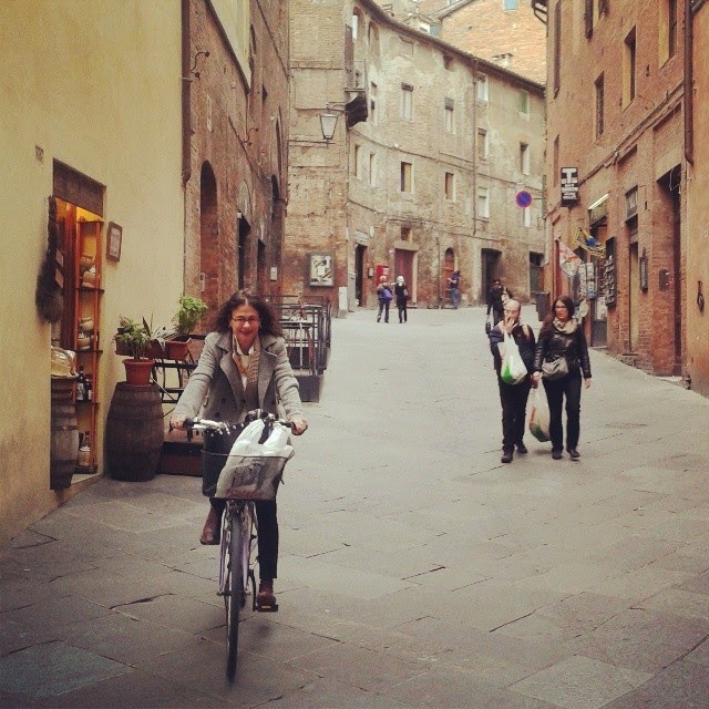 Nina arriving on her bike for lunch in Siena's town center