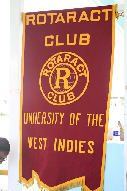 Photograph of a red banner with Rotaract club on it.