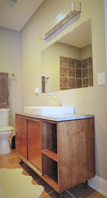 view of custom vanity and bathroom light