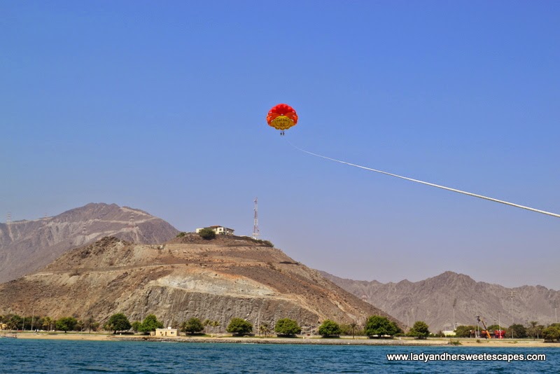 parasailing with a fantastic view of the Hajar Mountains 