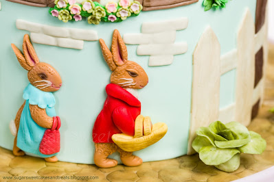 Flopsy and Benjamin Bunny attached to the side of the cake.