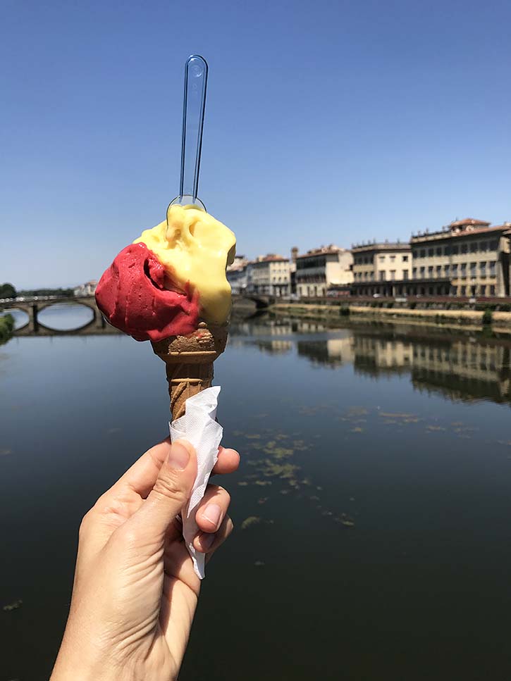 The best Florence Italy Gelato A pretty cone of raspberry and passionfruit gelato in front of the Arno river