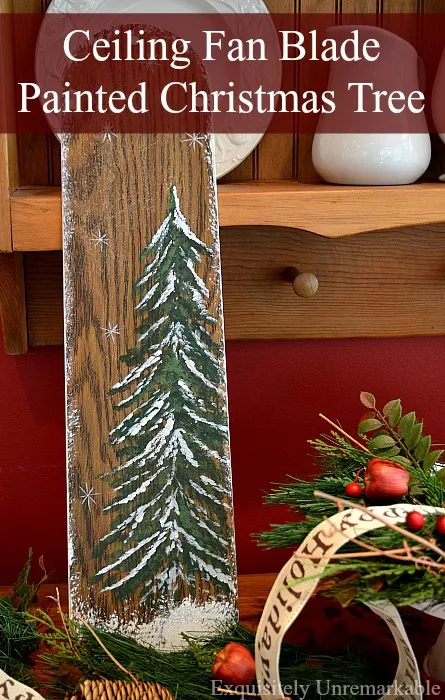 Ceiling Fan Painted Christmas Tree text over photo of painted fan blade on a table with Christmas decor