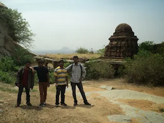 Hikers exploring a narrow passage and gate in the fort ruins