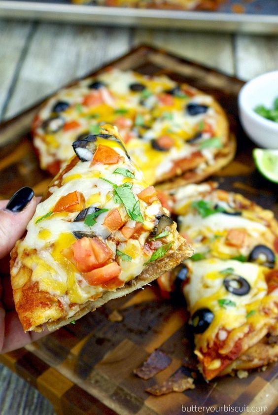 These Mexican Pizzas are so much better then….you know that one little building with a drive thru and I think it has a bell on it. Yes that one….Well it has always been my favorite on the menu. Pretty brilliant combining two of my favorite foods pizza and tacos, this one is definitely a MUST make!