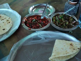 Riders taking a break next to their bikes on the hot highway