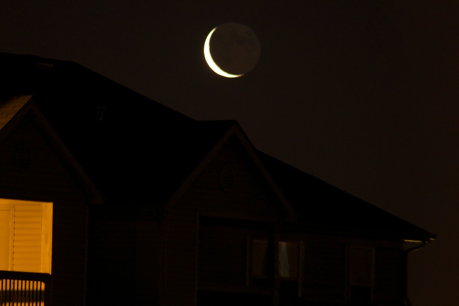 crescent moon over roof