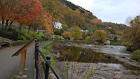 Autumnal scene at the riverside in Llangollen. Colours of autumn on the mountainside along the river Dee in Llangollen