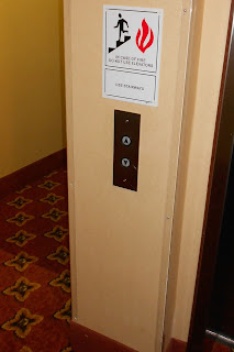 elevator with sign: in case of fire do not use elevator, use stairs