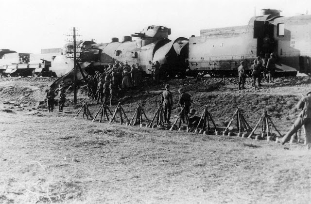A damaged Polish armored train carrying tanks captured by the 14th SS-Leibstandard Adolf Hitler Division, near Blonie, during the invasion of Poland in September of 1939.