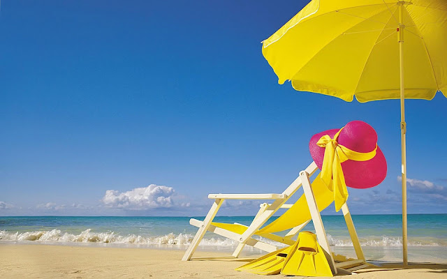 Wwitte strandstoel en gele parasol op het strand
