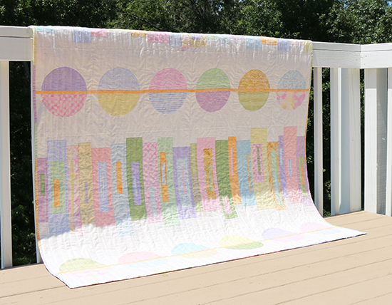 Front of Pastel Modern Quilt Featuring Circles and Stacked Rectangles