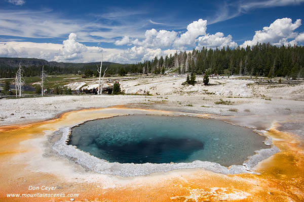 Blue skies reflected in the waters of Crested Pool, Yellowstone National Park, Wyoming, USA.
