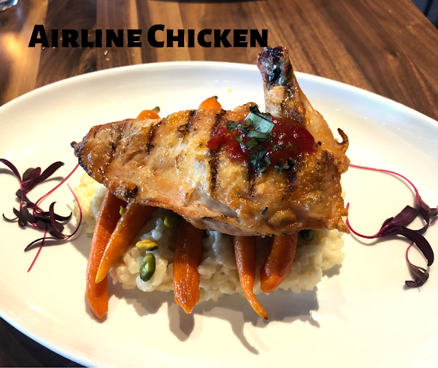 Delectable Airline Chicken atop carrots and lemon risotto at Hey Nonny in Arlington Heights, Illinois