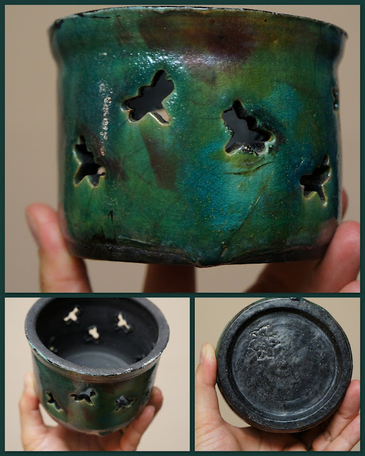 Raku pottery candleholder with dragonfly cutout pattern.