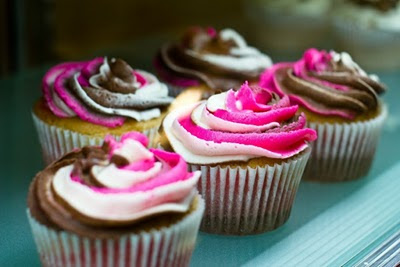 Swirls of multi-coloured cream decorate the top of these cupcakes!