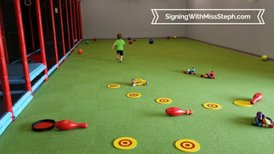 Sports court floor covered with discs, balls, and rubber animals