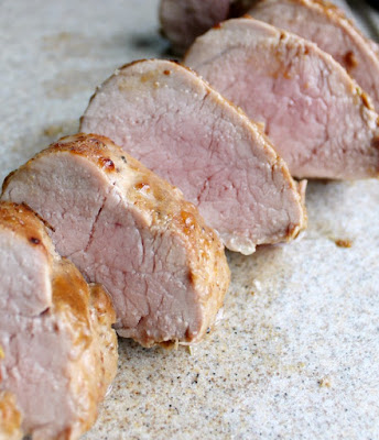 slices of pork tenderloin with blush of pink showing