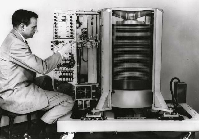 A photo of the first disk drive, the IBM 350. From the side, you can see a stack of round platters.