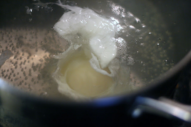 Egg slowly poaching in hot but not boling water