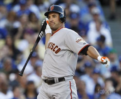 San Francisco Giants' Pat Burrell throws his bat after striking out against the Los Angeles Dodgers in the fourth inning in their Opening Day MLB National League baseball game in Los Angeles, California March 31, 2011. REUTERS/Alex Gallardo