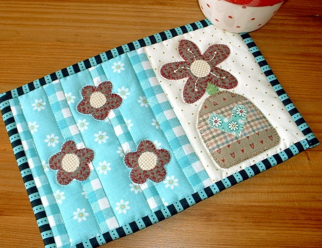 http://www.craftsy.com/pattern/quilting/home-decor/flower-vase-mug-rug/45542