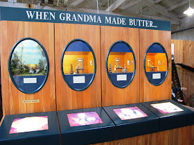 Display of model scenes depicting the four stages of making butter.