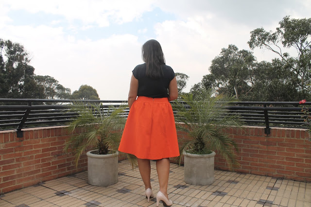 Orange faille skirt sewn from the Simplicity 1369 sewing pattern.