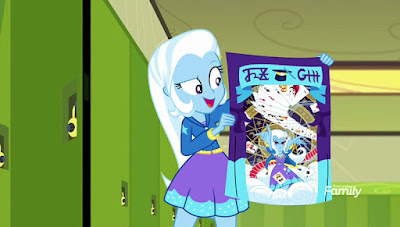 Trixie enthusiastically holds up a poster promoting her magic show