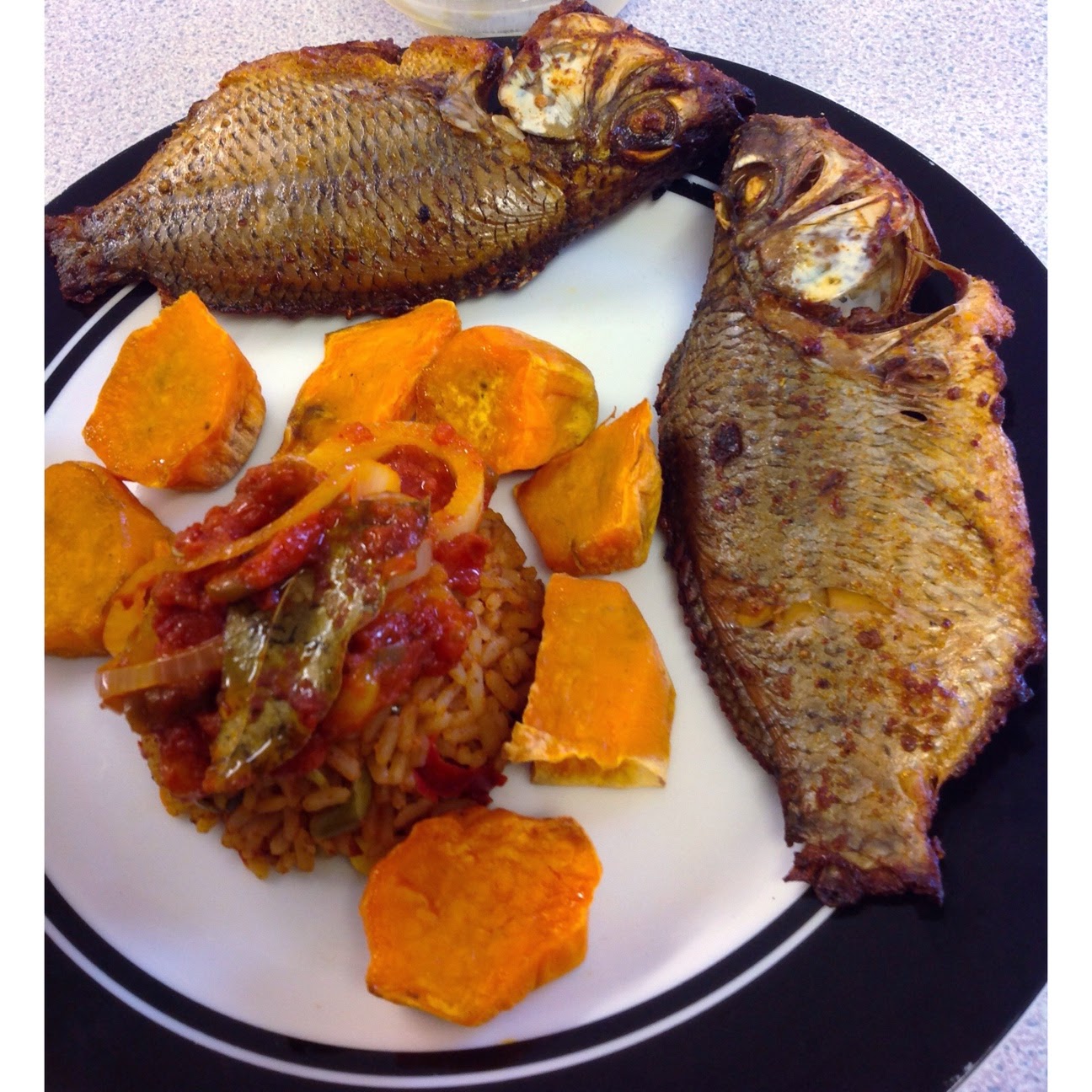JOLLOF RICE, SWEET POTATOES WITH TILAPIA FISH